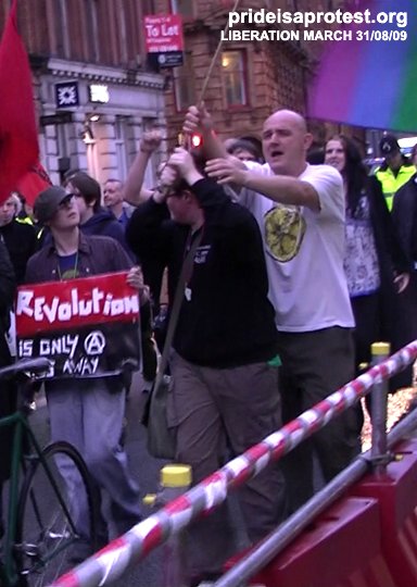 A man tries to grab a flag at the Liberation09 march